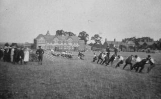 Soldiers engaged in a tug of war contest with local residents in the Wolverton Secondary School field, adjacent to the garden in Stacey Aveneue where the buttons were found