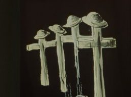 Black and white drawing of four crosses with soldiers hats on top.