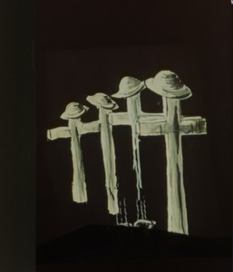 Black and white drawing of four crosses with soldiers hats on top.