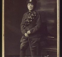 Slide of a woman in a man's military uniform.