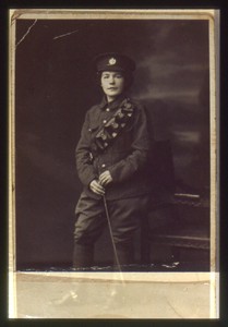 Slide of a woman in a man's military uniform.