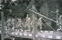 Slide of a Scottish Regimental Pipe-Band crossing a bridge.