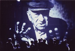 Photograph of a projection of a large image of Hawtin Mundy.