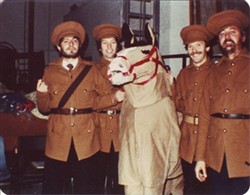 Photograph of four men dressed as soldiers and a costume horse.