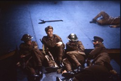 Colour slide of four soldiers lying on the floor.