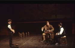 Slide of a soldier and man sat at a table with a second person to one side