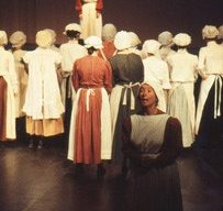 Slide of a crowd of women facing a woman on stage
