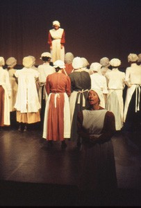 Slide of a crowd of women facing a woman on stage