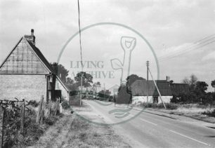 Photograph of road through Woolstone towards the church (1971).