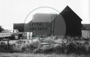 Photograph of farm building and tractor at Woolstone (1971).