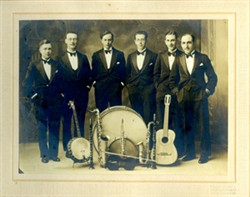Six gentlemen and musical instruments.