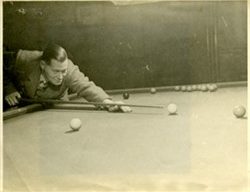Photograph of Frank Brown playing billiards.