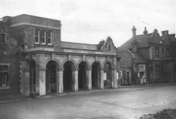Bletchley station entrance 1952 showing  horse mounting stone near the first pillar.  (Accession Ref: RWS/P/226).