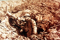 Slide of a photograph of a soldier stood in a trench