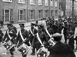 Military band marching through Wolverton