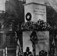 War memorial decorated with flowers