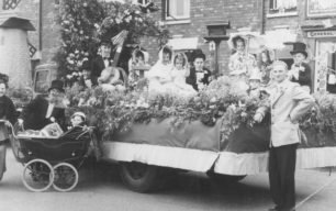Bill Alderman standing by one of the floats "The English Garden".