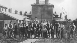 Group of boys gardening near Railway Cottages.