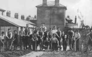 Group of boys gardening near Railway Cottages.