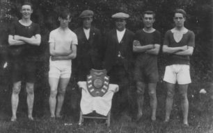 Swimming team with trophy.