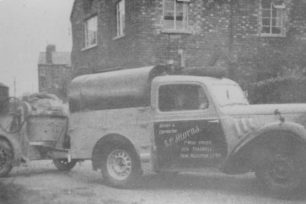 E P Hiorns (Builder & Contractor) pickup truck towing a cement mixer.