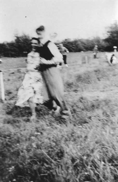 Young couple running in a field.