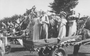 Carts decorated for a parade, one with children holding drinks