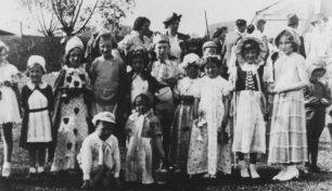 A group of children dressed in a variety of costumes