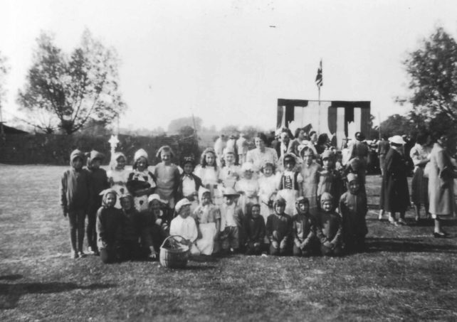 A group of 24 children dressed up in various costumes
