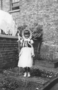 Girl dressed up as Bo Peep, in a back garden