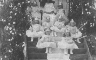 1921 carnival group sitting on a stepped podium