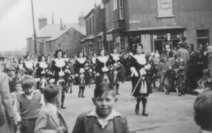 The Dagenham Girl Pipers lead a parade round New Bradwell