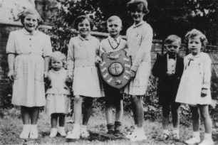 Young Wood Street residents with the trophy for best decorated street on the occasion of the 1953 Coronation