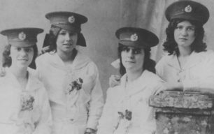 Four Girls in military hats. During 1914-18 War.