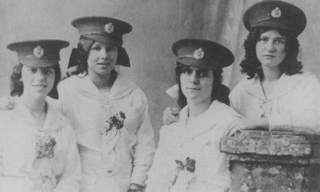 Four Girls in military hats. During 1914-18 War.