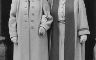 Two ladies, smartly dressed in coats.