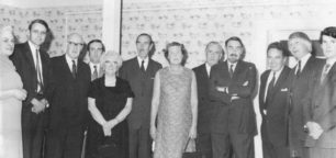 Group of men and women in formal dress.