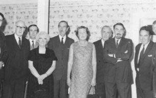 Group of men and women in formal dress.