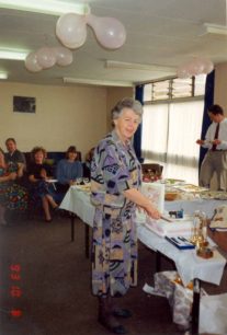 Daphne Capp cuts her retirement cake in the staff room at Leon School.