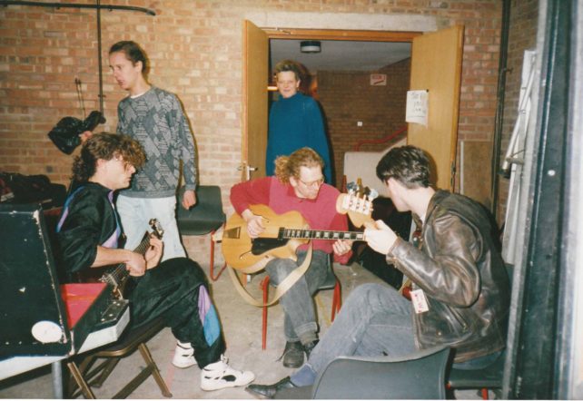 Three guitarists backstage