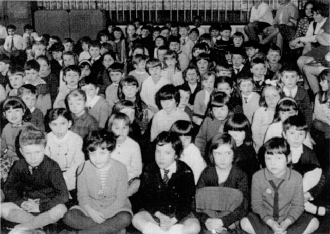 Infants seated on the floor in the hall 1969/70