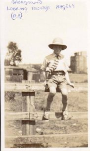 Boy on fence - Nagels in background