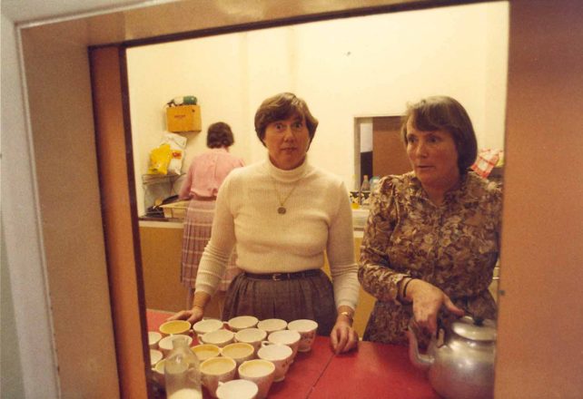 Two women serving tea