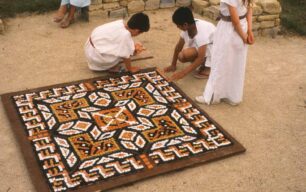 Children finishing clay mosaic