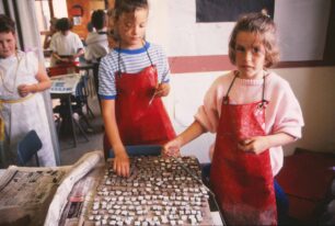 Two girls painting tesserae