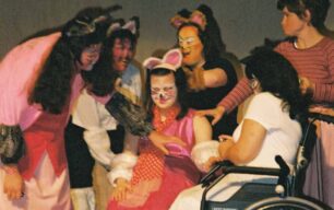 Group on stage with feline painted faces