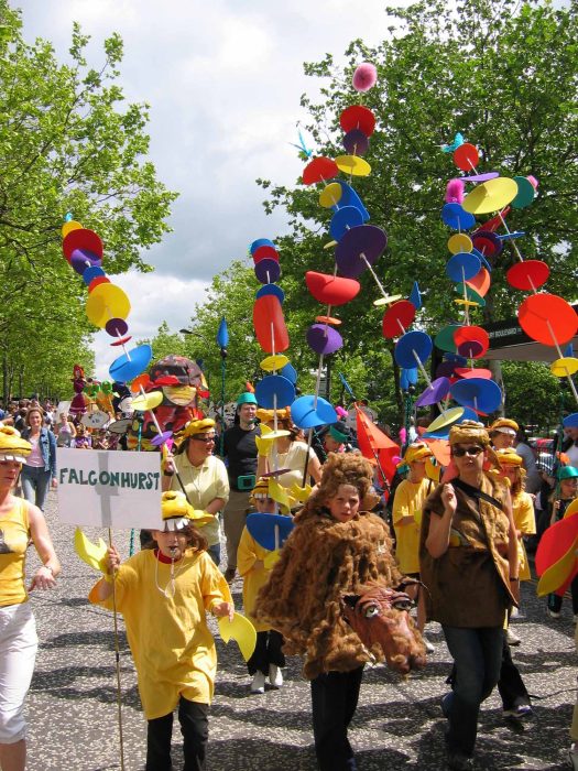 Group carrying tall colourful discs