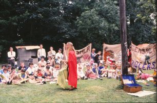 Densala tribe watch a performer in red