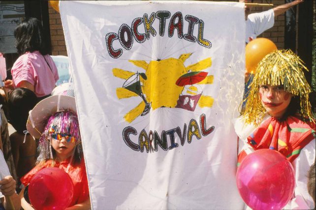 Two children in costume with banner