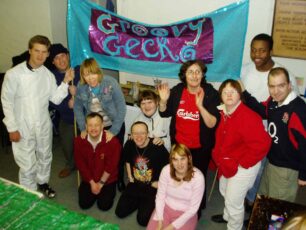 The crew with a finished Groovy Gecko banner